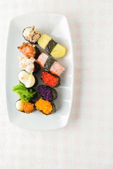 Sushi on white plate, tuna, salmon, sea bass, sweet egg, shrimp sushi, Japanese food
