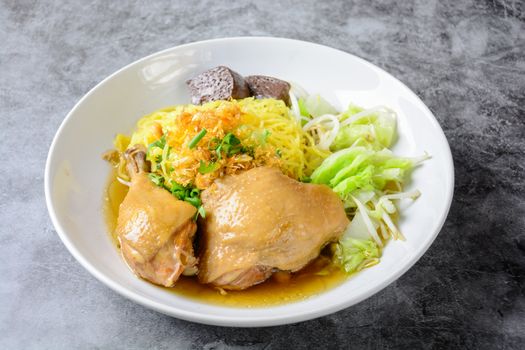 a plate of chicken and noodles soup with vegetables