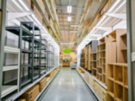 Blur furniture store interior for background. blurry industrial furniture merchandise inventory and wood material.
