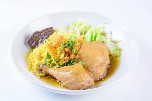 a plate of chicken and noodles soup with vegetables