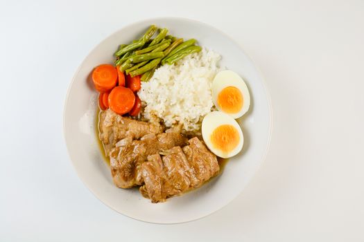 Baked pork ribs with rice, boiled egg and vegetable