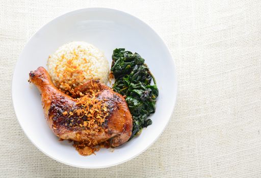 Chicken drumstick marinated with spicy chilli sauce and herbs, served with cooked rice and spinash.
