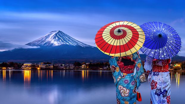 Asian womans wearing japanese traditional kimono at Fuji mountain, Kawaguchiko lake in Japan.