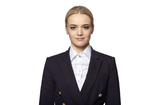 Studio portrait of young confident elegant businesswoman in a dark business suit.