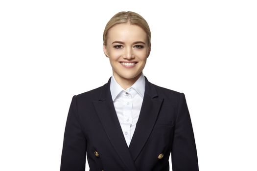 Portrait of cheerful young blonde woman in a dark business suit. Studio shot isolated on white background.