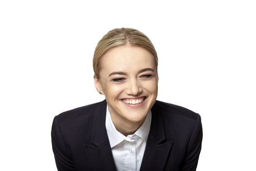 Studio shot of young blonde woman laughing isolated on white background.