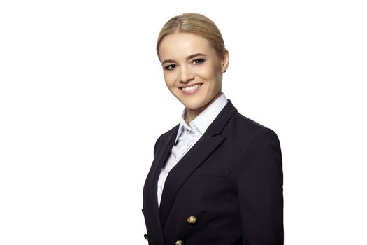 Friendly smiling young business woman in a dark business suit isolated on white background.