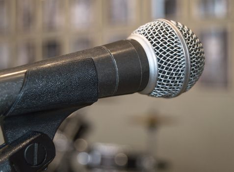 Microphone close-up, used by speaker to speak in conference room, seminar, University, lectures, blurred background.