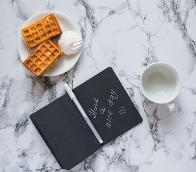 notebook with lettering on marble background