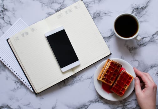 Woman are planning the day, coffee, waffles, marble background