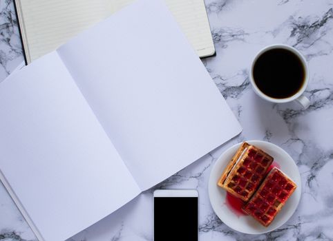 buisness lunch with coffe anf waffles and planning the day on marbel background