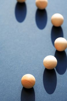 Abstract composition with few small wooden balls on dark blue background