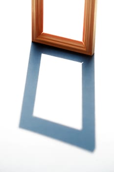 Empty wooden frame with long shadow against sunlight