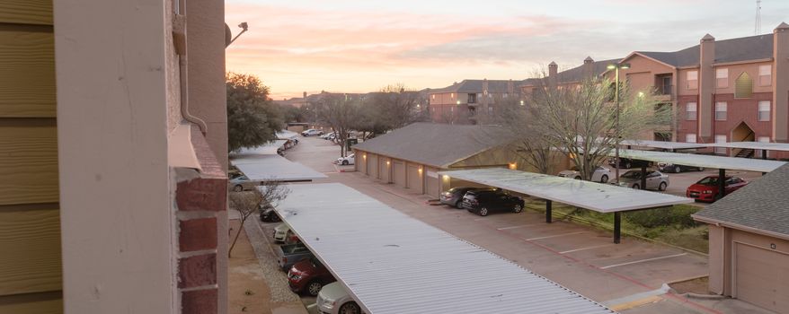 Panorama view typical aerial of apartment complex with detached garage and covered parking lots in Texas, America