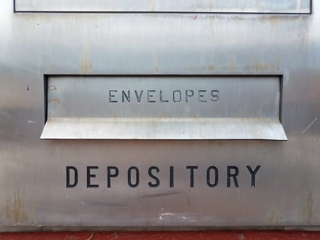 envelopes and depository sign with slot on silver metal at bank