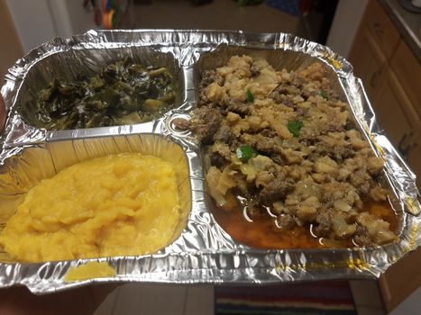 Ethiopian food greasy beef and intestine and spinach and yellow vegetable in kitchen