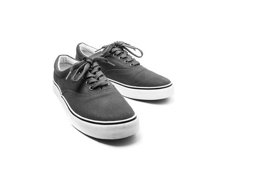 A pair of black canvas shoes isolated on white background with clipping path
