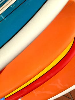 Colourful surfboards lined up in a row abstract