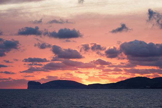 amazing red sunset on the giant that sleeps in Alghero, Sardinia, Italy