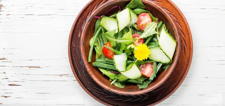 Vegetable salad with fresh lettuce in clay pot.