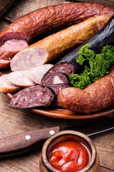 Delicious snack salami.Food tray with delicious sausages and fresh salami