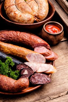 Delicious snack salami.Food tray with delicious sausages and fresh salami