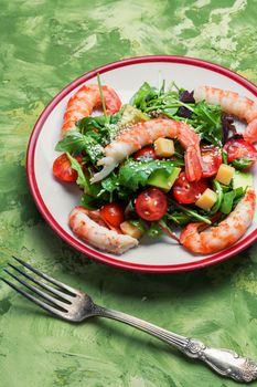 Healthy salad of shrimp, mixed greens and tomatoes.Seafood salad