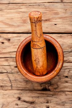 Empty wooden mortar and pestle on wooden old background