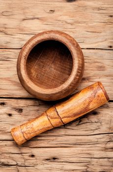 Empty wooden mortar and pestle on wooden old background