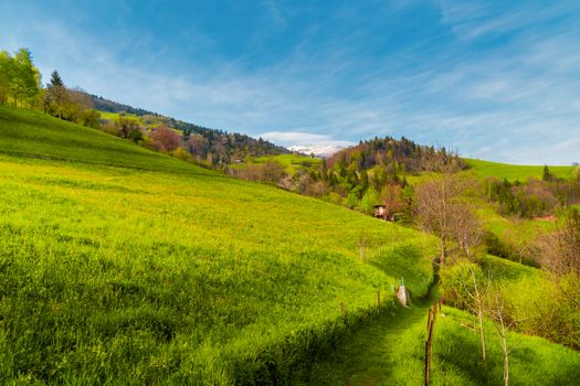 Panorama of green hills in Orobie mountains,background view of mountain peaks in spring time with snow, Seriana valley near Bergamo,Lombardy,italy