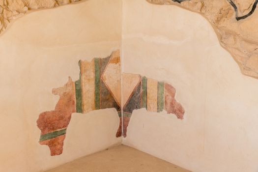 leftovers of old wall paintings at the ruins of the ancient Masada fortress in Israel,build by Herod the great