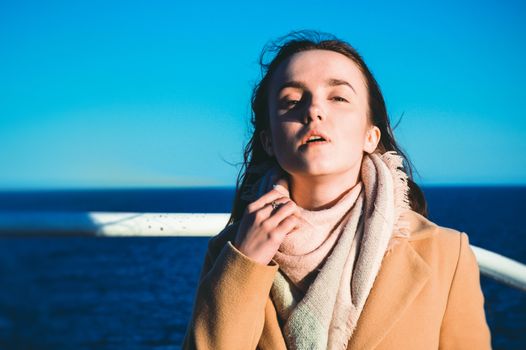 Close up portrait woman enjoying the sea from ferry. Sea life, spring vacations, casual wear, wind, pretty face, fashion portrait, model