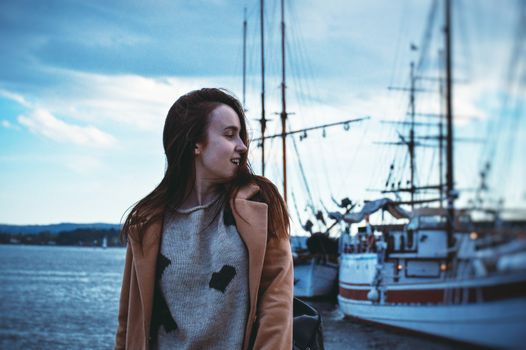 Adorable woman on blue yachts background and the sea