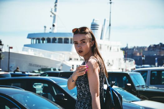 Adorable woman on blue yachts background and the sea