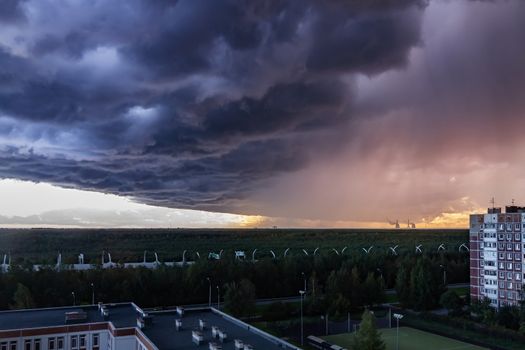 huge thundercloud on the outskirts of the city before the rain - image.