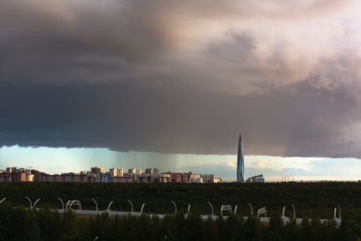 huge thundercloud on the outskirts of the city before the rain - image.