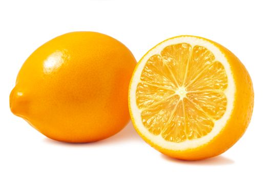 Fresh orange Tashkent lemons or Meyer lemons, one whole and one half isolated on white background with shadow.