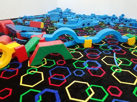 blue foam blocks and black carpet with hexagon carpet or rug