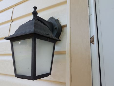 brown and grey moth insect with wings on white house or home siding and light