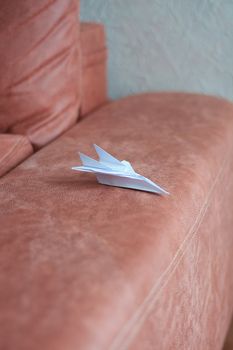Paper plane model. Origami. Handmade paper plane. Travel concept. White paper plane model.
