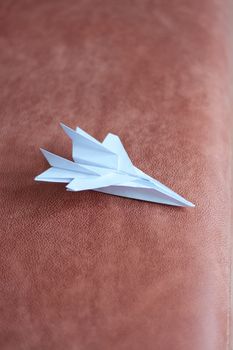 Paper plane model. Origami. Handmade paper plane. Travel concept. White paper plane model.