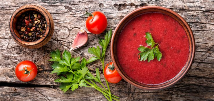 Gazpacho tomato soup in bowl on rustic wooden table.Spanish, Mediterranean cuisine