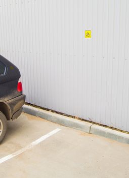 Reserved Parking sign for disabled small size on metal fence, accessible environment for people with disabilities.