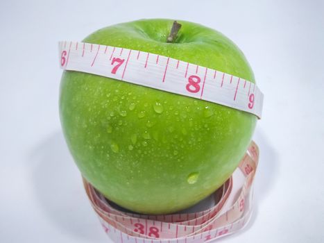 Green Apple Wrapped Around with a Measuring Tape