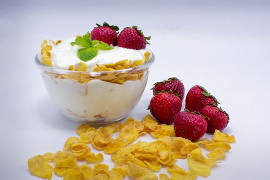 A Bowl Filled with Yogurt, Strawberry and Corn Flakes