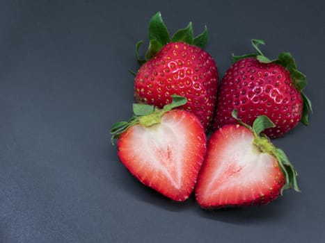 Fresh Strawberries Proudly Displaying Themselves on a Black Plate