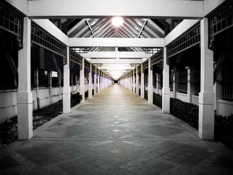 A Perspective Down a Long Outdoor Corridor in the Evening with Balanced Lines