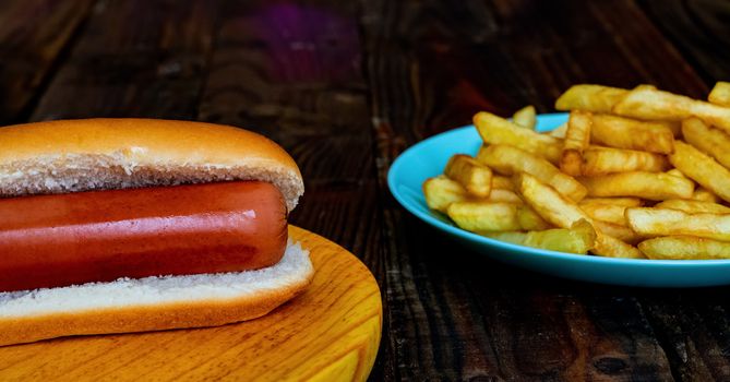 Hot dog and chips on wooden background