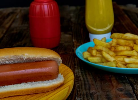 Hot dog and chips on wooden background