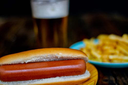 Hot dog and chips on wooden background